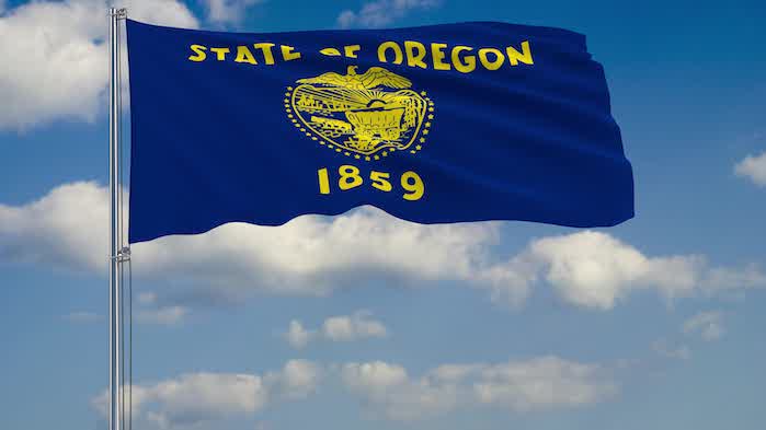 Flag of Oregon - US state fluttering in the wind against a cloudy sky 3d rendering